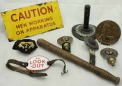 A box containing an enamelled sign inscribed "Caution Men Working On Apparatus",