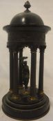 A Neo Classical bronze and carved stone garniture piece, the finial as flaming torch above the dome,