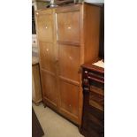 An early 20th Century oak Cotswold School cupboard,