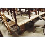 A pair of oak rectangular refectory tables on trestle stile supports