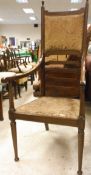 A mahogany framed ladder back chair with upholstered seat and back on turned tapering supports to
