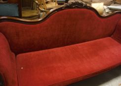 A 19th Century walnut framed sofa in red upholstery,