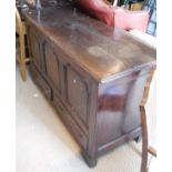 An oak mule chest with three panel front above the two drawers to bracket feet
