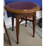 A pair of oak and red leather inset top circular tavern tables on turned supports