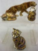 A Royal Dux figure of a prowling tiger and three Royal Crown Derby figures of cats with gold