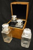 Four cut glass decanters in an oak box,