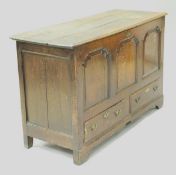 An oak mule chest with three panel front above the two drawers to bracket feet,