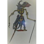 Two Javanese shadow puppets, one with turned rhino horn handle,