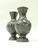 A pair of late 19th/early 20th Century Chinese bronze baluster shaped vases,