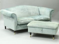 A pair of modern aquamarine upholstered scroll arm three seat sofas on turned front legs to brass