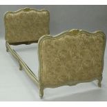 A 20th Century day bedstead in the French taste with cream gilt carved frame and peach and cherub