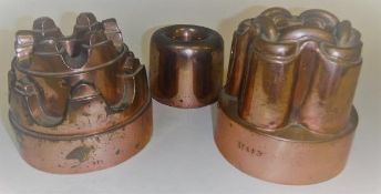 Three Victorian copper jelly moulds, one with chain link motif to top, marked "M443", 14 cm high,