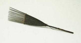 A 19th Century wooden comb bearing label "Comb Solomon Islands",