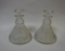 Two Georgian ship's decanters, the bodies of ribbed form and with star cut base,