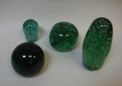 Four Victorian green glass dump paperweights with bubble decoration, tallest approx 21.