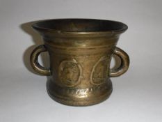 A 17th Century bronze mortar, the tapering body with two loop handles,