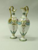 A pair of Royal Crown Derby cabinet ewers with gilded floral spray and turquoise banded decoration,