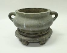 A Chinese bronze censer with Xuande six character mark to base, raised on a hardwood stand,