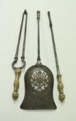 A set of three iron fireside tools with embossed brass handles,