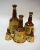 A collection of five pottery Bells Old Scotch Whisky bell-shaped bottles,