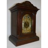 An oak cased mantle clock with Arabic numerals to the chapter ring and chime/silent dial and