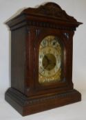 An oak cased mantle clock with Arabic numerals to the chapter ring and chime/silent dial and