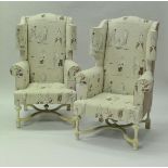 A pair of modern wing back armchairs in the 17th Century manner with cream upholstery depicting