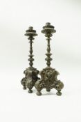 A pair of late 17th Century Italian carved limewood candlesticks,