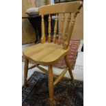 A set of four modern stained beech framed stick back kitchen chairs together with an upholstered