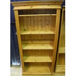 A pair of modern pine open bookcases with adjustable shleving