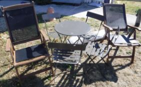 A modern painted metal bistro type garden table and four folding chairs,