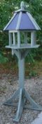 A painted pine bird table of architectural form