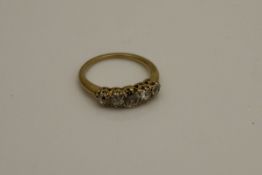 An un-marked gold five stone set diamond ring, approx 0.65 carat weight, 3.