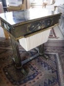A Victorian black lacquered work table with painted floral spray to the lift top lid,