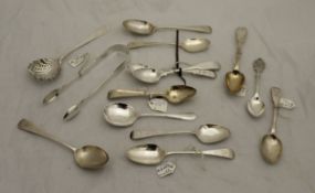 A box containing assorted silver teaspoons and a silver sifter spoon, various dates and makers,