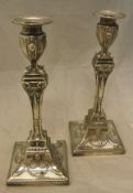 A pair of Edwardian silver candlesticks in the Egypto Classical taste (by R Hodd & Son London 1909)