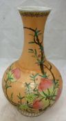 A 20th Century Chinese baluster shaped vase decorated with peaches with six character mark to base