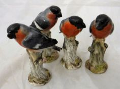 Four 19th Century Meissen figures of bullfinches on tree stumps bearing incised numbers "904" (x 3)