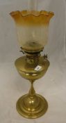 A Victorian brass oil lamp with floral etched clear and yellow shade,