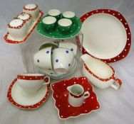 A Jessie Tait for Midwinter part dinner and tea wares decorated in a cream ground with red and