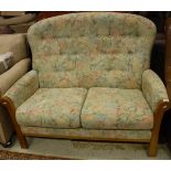A Cintique beech framed two seat sofa with floral upholstery and a G Plan brown leather upholstered