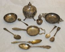 A box containing assorted sundry silver items to include a George II twin-handled lemon strainer