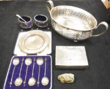 A box containing a small silver alms style dish,