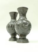 A pair of late 19th/early 20th Century Chinese bronze baluster shaped vases,