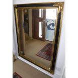 A large bevelled mirror with gilt and ebonised frame
