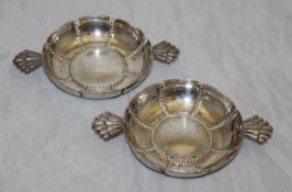 A pair of silver twin-handled pin dishes of lobed wine taster form (by Goldsmiths & Silversmiths
