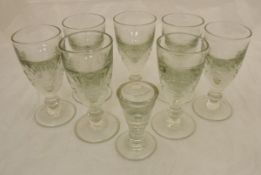 A set of seven late 18th/early 19th century wine glasses, with cut decoration to the bowl,