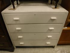 A mid 20th Century white painted chest of four long drawers