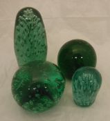 Four Victorian green glass dump paperweights with bubble decoration