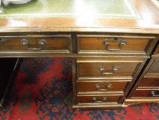 A modern mahogany double pedestal desk with tooled and guilded leather insert top over three